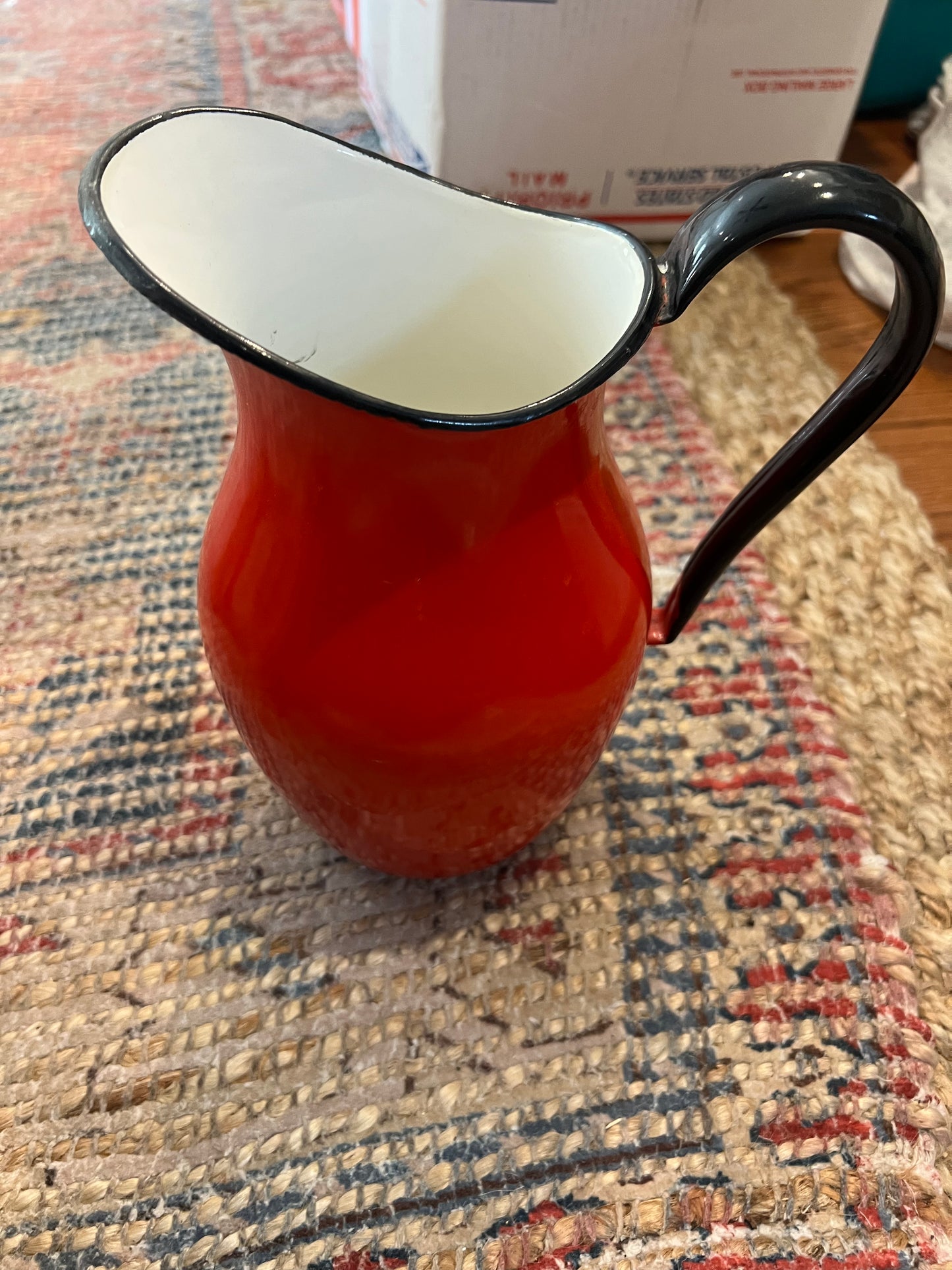 Vintage red enamelware pitcher